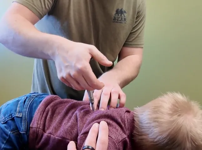 Close-up of an activator adjustment on a child's back