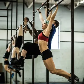 Woman doing hanging exercises at a crossfit gym