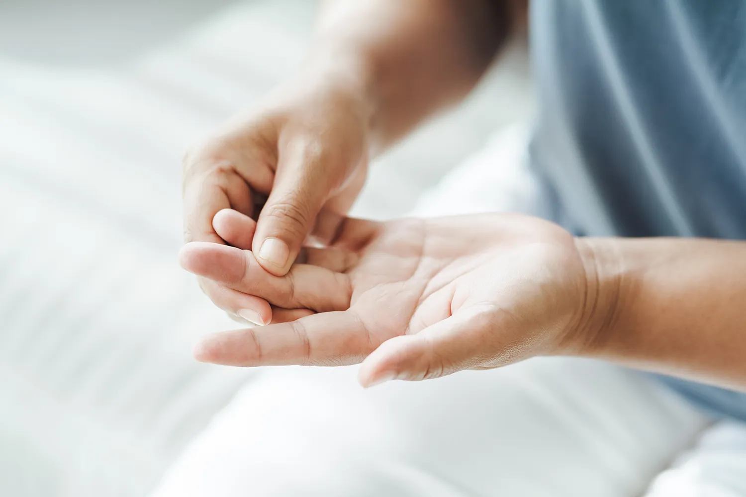 Woman massaging the palm of her hand