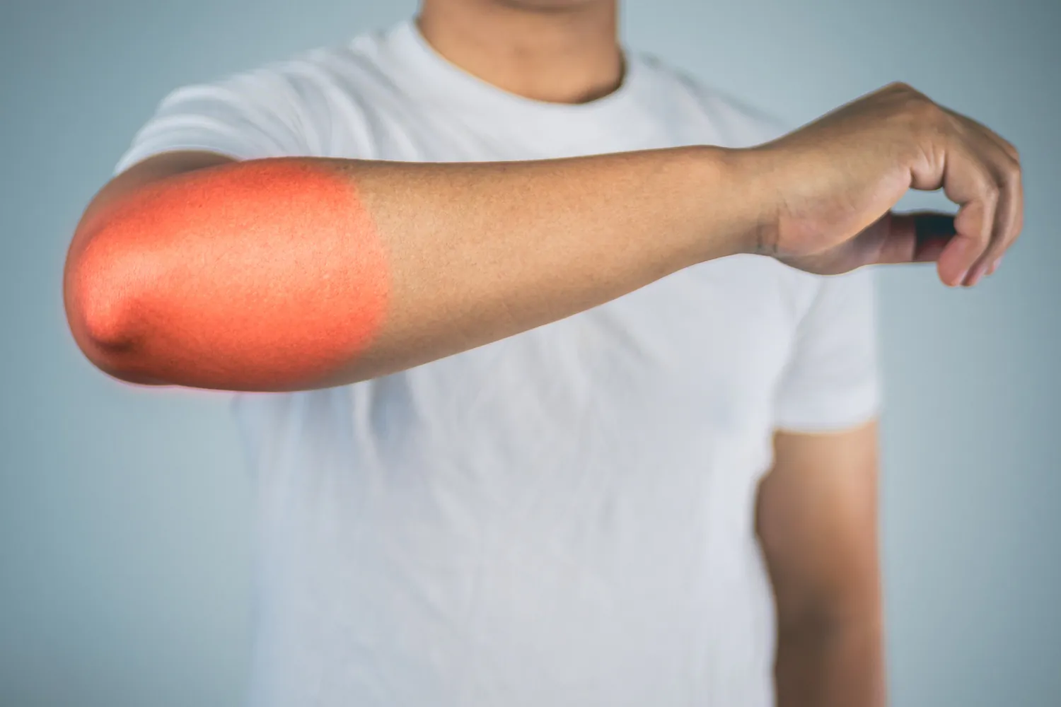 Man's arm with the elbow highlighted red