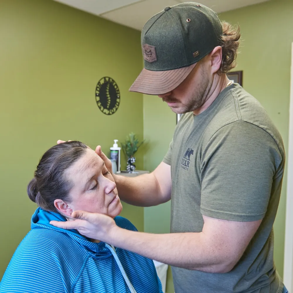 Chiropractor adjusting the neck of a female patient