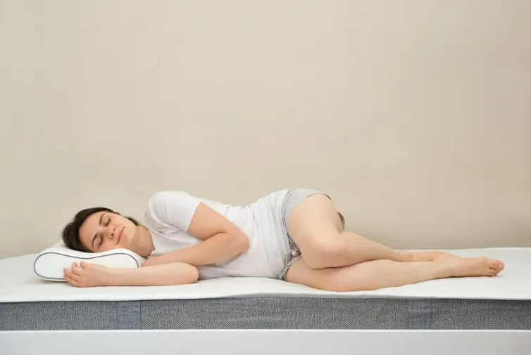 Woman sleeping on her side on a pillow